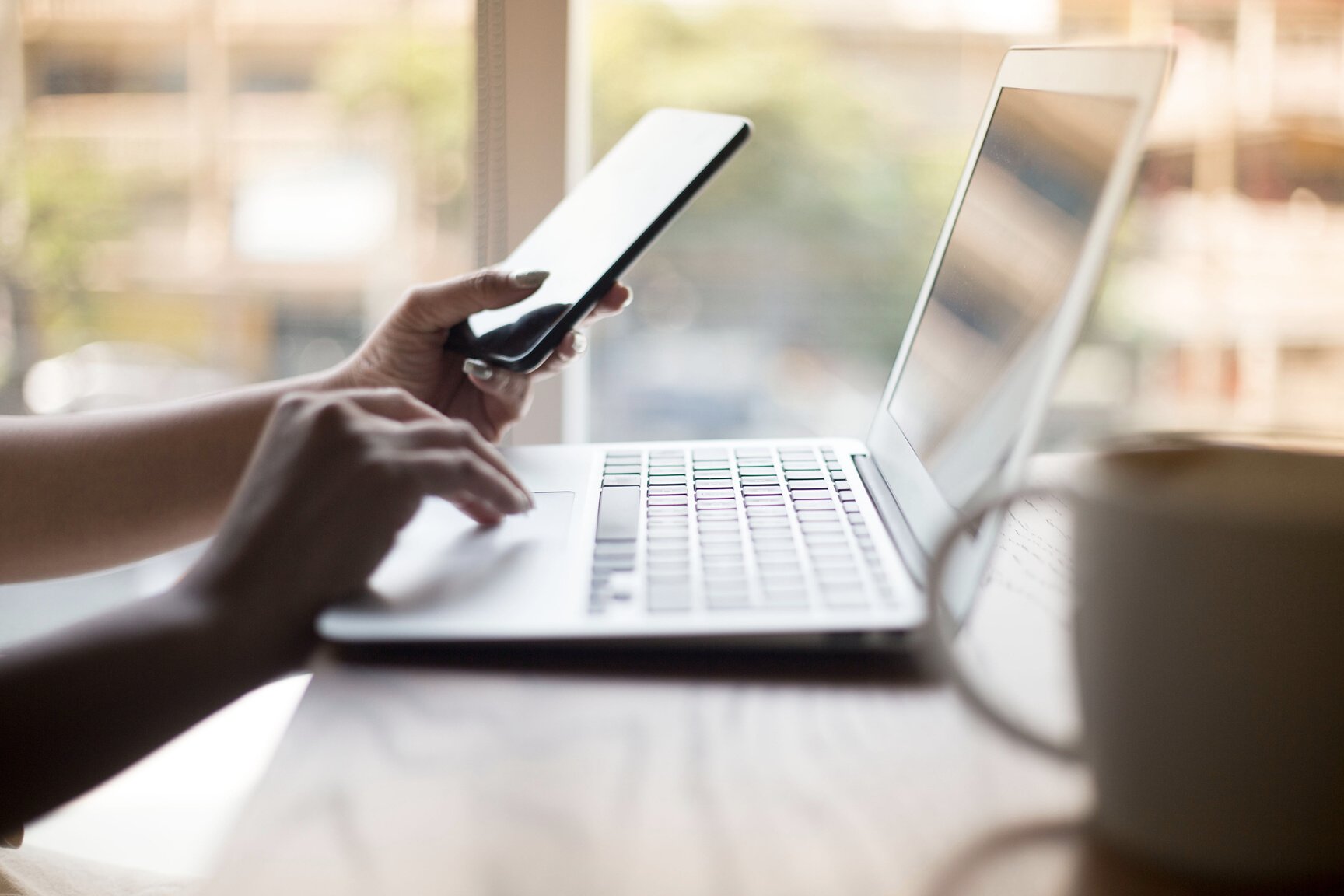 Young Beautiful Asian Women Using Computer and Phone